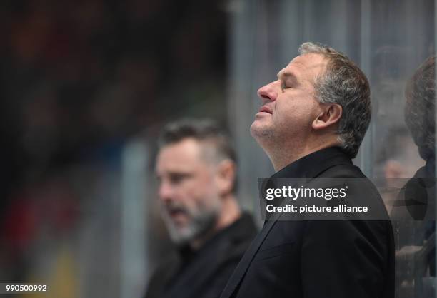 Nuernberg coach Rob Wilson closes his eyes during the DEL ice hockey match between EHC Red Bull Muenchen and Nuernberg Ice Tigers at the...