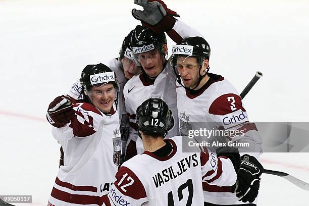 Aleksandrs Nizivijs of Latvia celebrates his team's first goal with team mates during the IIHF World Championship group C match between Italy and...