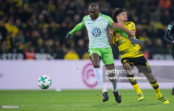 Wolfsburg's Josuha Guilavogui and Dortmund's Mahmoud Dahoud vie for the ball during the German Bundesliga football match between Borussia Dortmund...