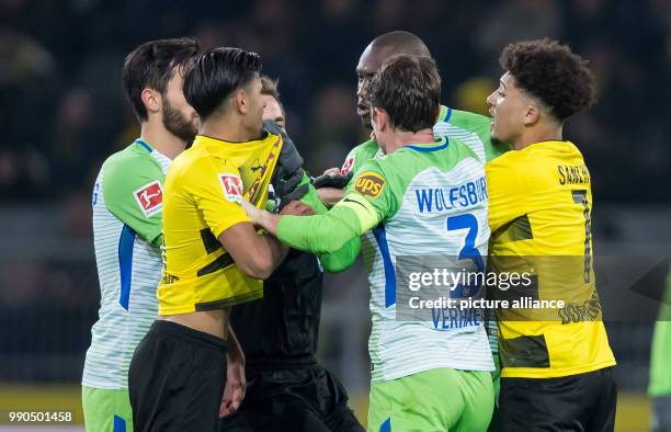 Dortmund's Mahmoud Dahoud scuffles with Wolfsburg's Josuha Guilavogui during the German Bundesliga soccer match between Borussia Dortmund and VfL...