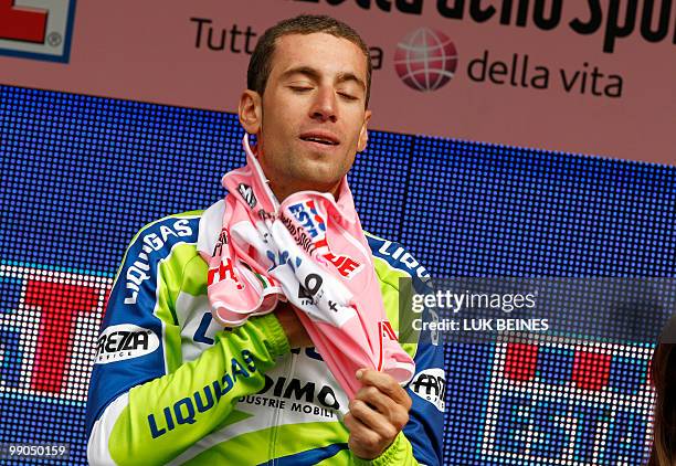 Italia's Vincenzo Nibali of the Liquigas-Doimo team wears-on his pink jersey on the podium after winning the fourth stage of the 93rd Giro d'Italia,...