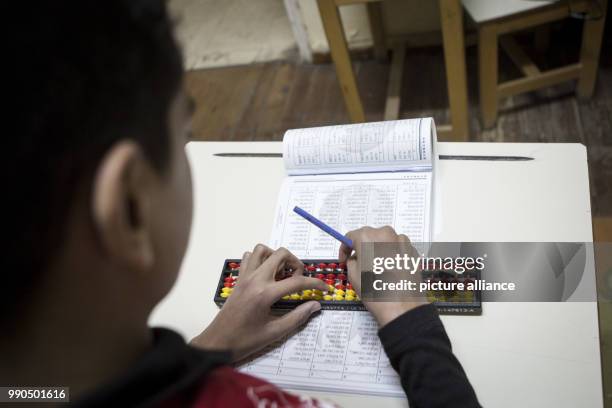 Egyptian child Abdulrahman Hussain who has titled the 'Smartest Child in the World' solves an arithmetic problem during an interview with the German...