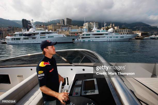 Sebastian Vettel of Germany and Red Bull Racing pilots a boat in the harbour during previews to the Monaco Formula One Grand Prix at the Monte Carlo...