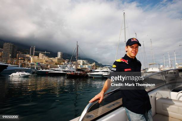 Sebastian Vettel of Germany and Red Bull Racing pilots a boat in the harbour during previews to the Monaco Formula One Grand Prix at the Monte Carlo...