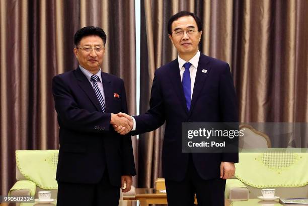 South Korean Unification Minister Cho Myoung-gyon shakes hands with North Korean Vice Sports Minister Won Kil-u during their meeting at Pyongyang...