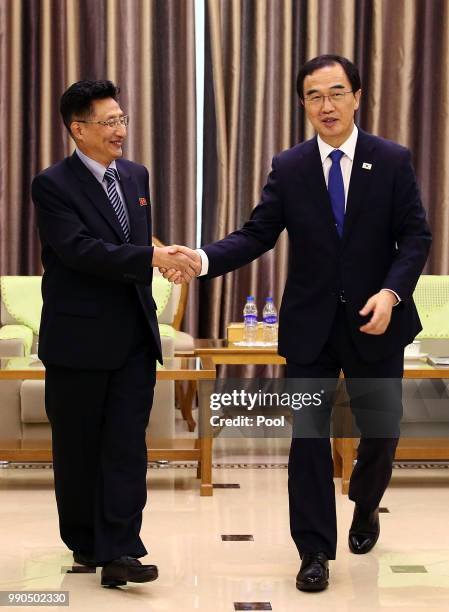 South Korean Unification Minister Cho Myoung-gyon shakes hands with North Korean Vice Sports Minister Won Kil-u during their meeting at Pyongyang...
