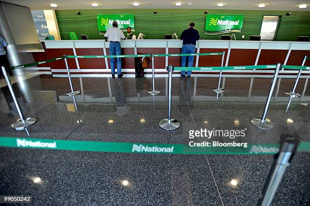 Travelers check in at the National car-rental counter at Hartsfield-Jackson Atlanta International Airport in Atlanta, Georgia, U.S., on Friday, May...