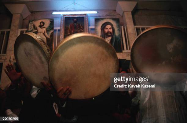 Remembrance ceremony of Kasnazani dervishes starts with slow beating of a tambourines and chanting the name of God. Pictures of Imam Ali and Abdol...