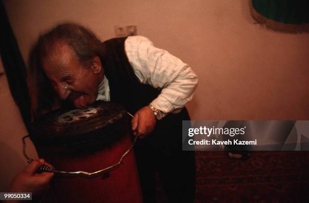 Khalife Hamma licks on a hot kerosene heater during a remembrance ceremony at his home in Sanandaj located in Kurdistan region of Iran. Kasnazani...