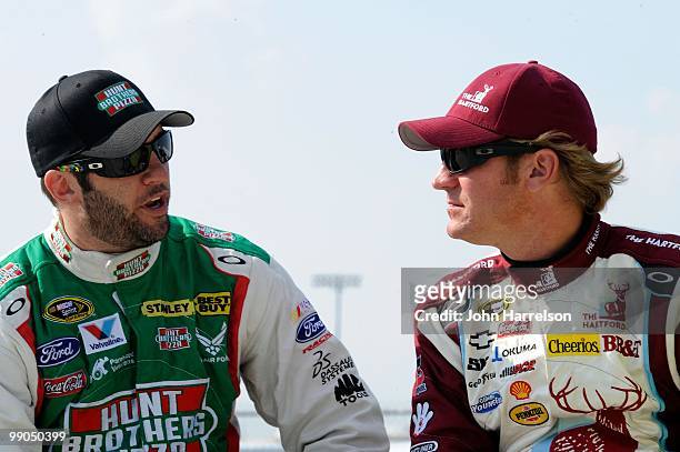 Elliott Sadler, driver of the Hunt Brothers Pizza Ford, talks with Clint Bowyer, driver of the The Hartford Chevrolet, during qualifying for the...