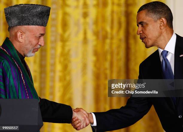 President Barack Obama and Afghanistan President Hamid Karzai shake hands during a joint news conference in the East Room of the White House May 12,...