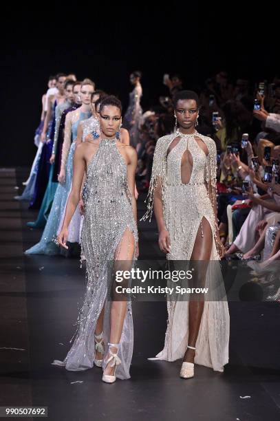 Models Cindy Bruna and Maria Borges lead the finale during the George Hobeika Haute Couture Fall Winter 2018/2019 show as part of Paris Fashion Week...