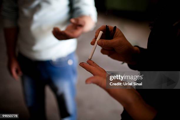 An Afghan migrant, held in a detention centre, burns skin of her fingers with a burning cigarette so she will not be recognized by finger prints...