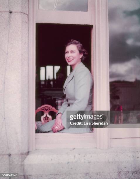 Queen Elizabeth II sitting in the window at Balmoral Castle in Scotland on 9 September 1952.