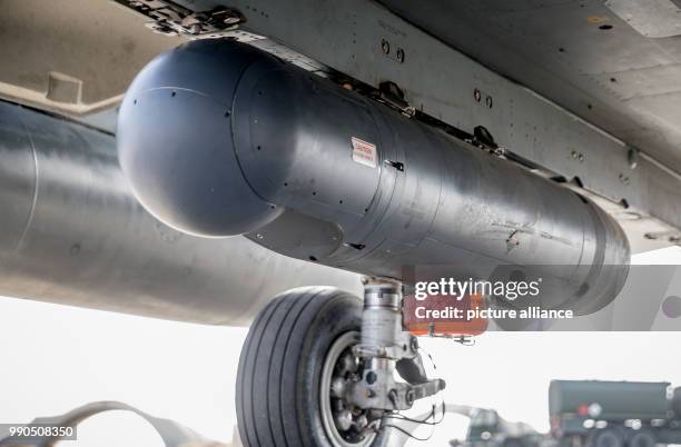 Container with a recording camera, the so-called recce pod, hanging from under a Bundeswehr Tornado jet fighter parked in the Al-Azrak air base in...