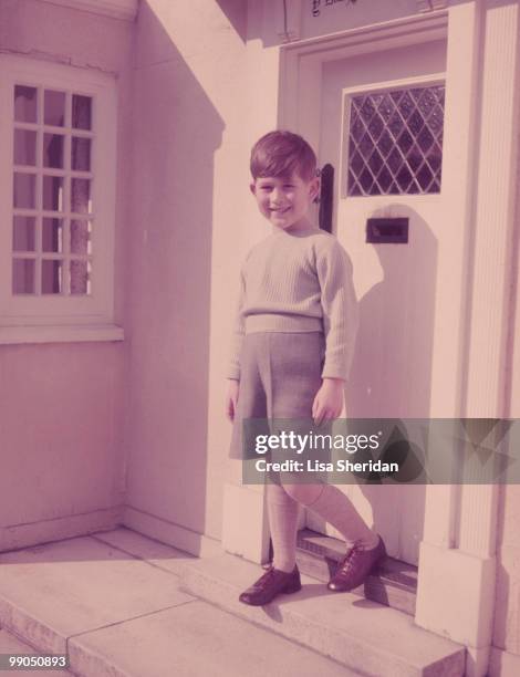 Prince Charles standing outside the Little Welsh cottage at the Royal Lodge in Windsor in England on April 7, 1954.