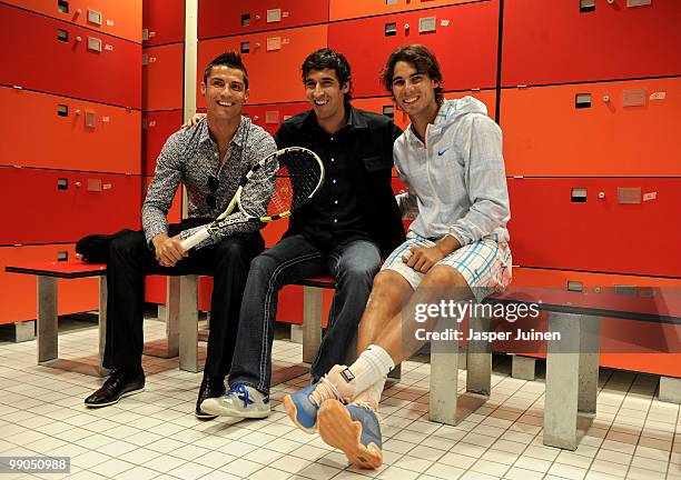 Cristiano Ronaldo and Raul Gonzalez of Real Madrid chat with Rafael Nadal of Spain after his second round match during the Mutua Madrilena Madrid...