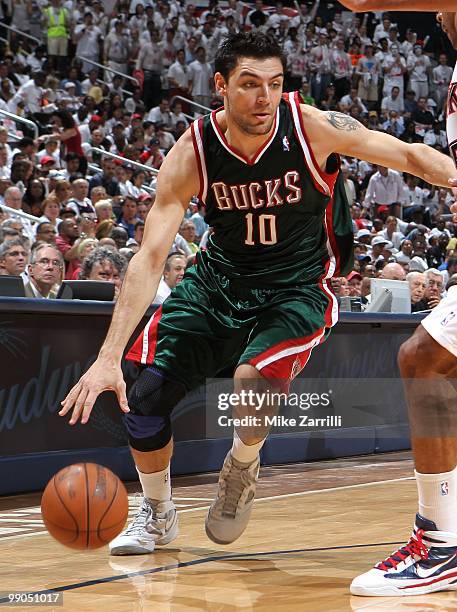 Forward Carlos Delfino of the Milwaukee Bucks dribbles with the ball during Game Seven of the Eastern Conference Quarterfinals between the Milwaukee...