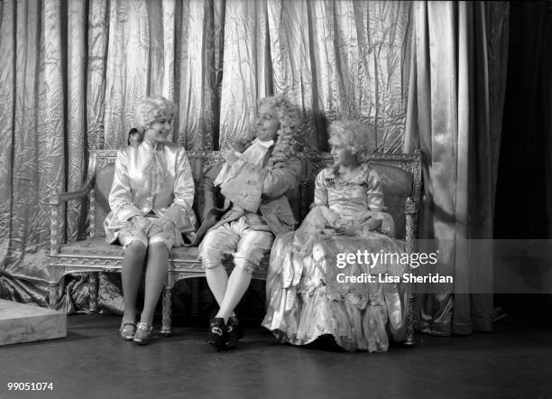 Princess Elizabeth dressed as Prince Charming, and Princess Margaret as Cinderella with an unspecified person during a royal pantomime at Windsor...