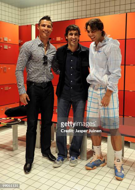 Cristiano Ronaldo and Raul Gonzalez of Real Madrid chat with Rafael Nadal of Spain after his second round match during the Mutua Madrilena Madrid...
