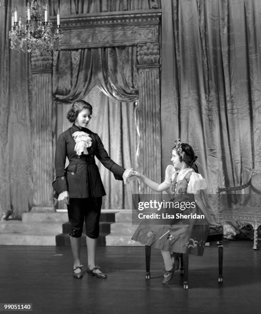 Princess Elizabeth dressed as Prince Charming with Princess Margaret as Cinderella during a royal pantomime at Windsor Castle, Berkshire, Great...