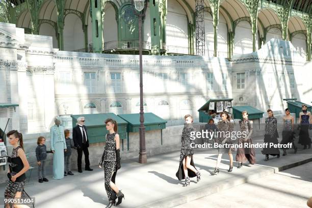 Model Adut Akech, Hudson Kroenig and Chanel Stylist Karl Lagerfeld acknowledge the applause of the audience at the end of the Chanel Haute Couture...