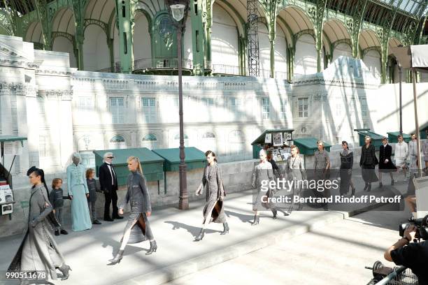 Model Adut Akech, Hudson Kroenig and Chanel Stylist Karl Lagerfeld acknowledge the applause of the audience at the end of the Chanel Haute Couture...