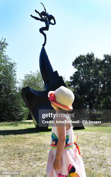 Three year old Layla studies Barry Flanagan's Large Nijinski on Anvil Point, during the media launch of the Frieze Sculpture outdoor exhibition in...