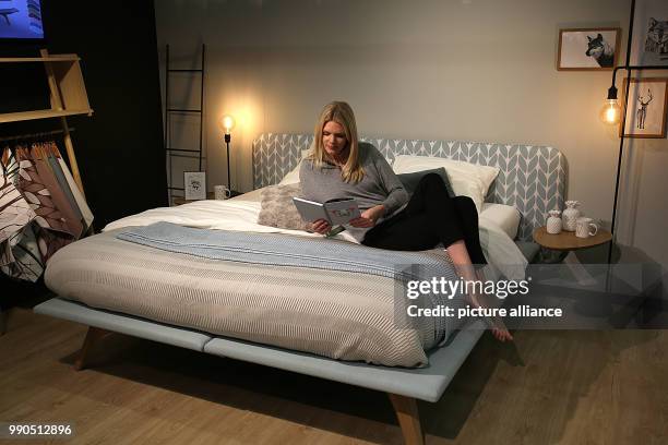 Model Alida sits on a box-spring bed with air circulation in Cologne, Germany, 15 January 2018. The International interiors show IMM will take place...