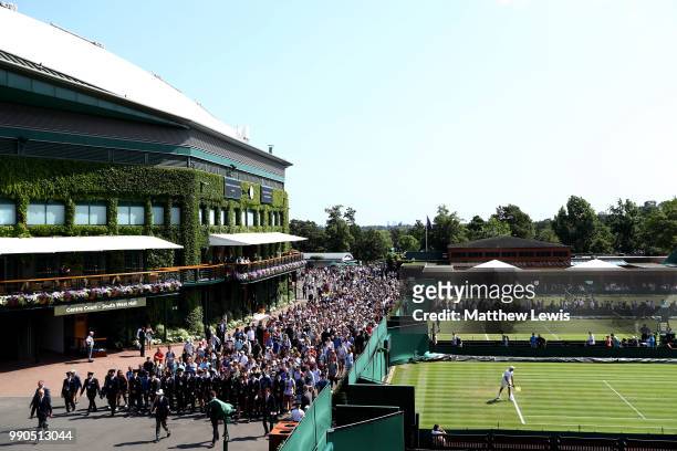 Crowd of fans wait to enter the courts on day two of the Wimbledon Lawn Tennis Championships at All England Lawn Tennis and Croquet Club on July 3,...