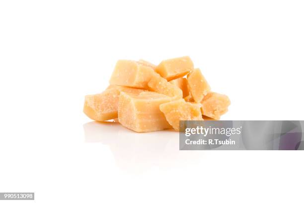 hard old cheese isolated on a white background - parmesan stock-fotos und bilder