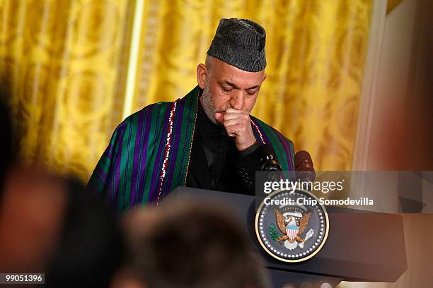 Afghanistan President Hamid Karzai listens to a question during a joint news conference with U.S. President Barack Obama in the East Room of the...