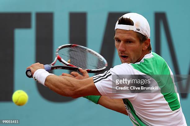 Jurgen Melzer of Austria plays a backhand against Mardy Fish of the USA in their second round match during the Mutua Madrilena Madrid Open tennis...
