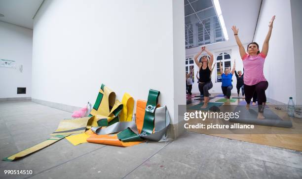 Women practice yoga during a yoga course behind the art work oto by Leni Hoffmann at the Gallery Stadt Sindelfingen in Sindelfingen, Germany, 11...