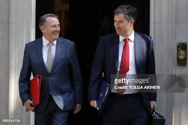 Britain's International Trade Secretary Liam Fox and Britain's Justice Secretary and Lord Chancellor David Gauke leave 10 Downing Street in central...
