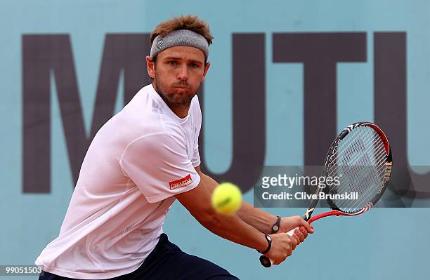 Mardy Fish of the USA plays a backhand against Jurgen Melzer of Austria in their second round match during the Mutua Madrilena Madrid Open tennis...