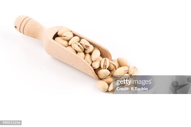 pistachio nut in scoop close up on white background isolated - crack spoon stock pictures, royalty-free photos & images