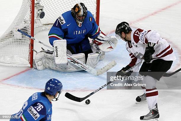 Herberts Vasiljevs of Latvia tries to score against goalkeeper Adam Russo of Italy during the IIHF World Championship group C match between Italy and...