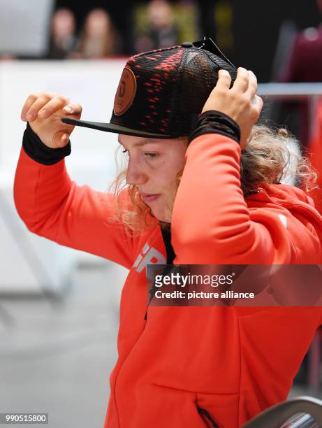 The biathlete Laura Dahlmeier puts on a hat during the official outfitting of the German Olympic Team for the Winter Olympics in Pyeongchang, South...