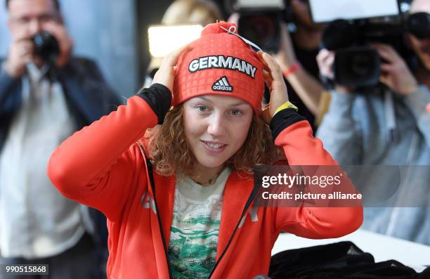 The biathlete Laura Dahlmeier puts on a hat during the official outfitting of the German Olympic Team for the Winter Olympics in Pyeongchang, South...