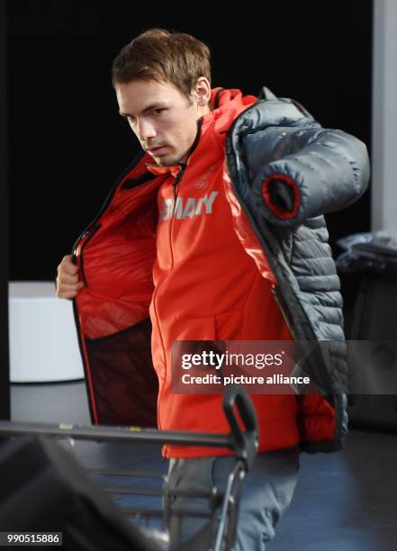 The biathlete Simon Schempp puts on a jacket during the official outfitting of the German Olympic Team for the Winter Olympics in Pyeongchang, South...