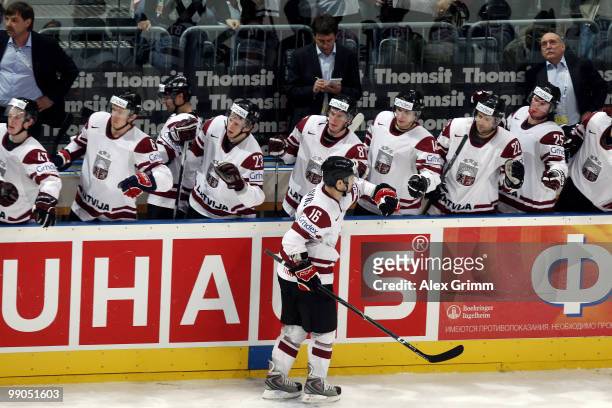 Kaspars Daugavins of Latvia celebrates his team's fourth goal with team mates during the IIHF World Championship group C match between Italy and...
