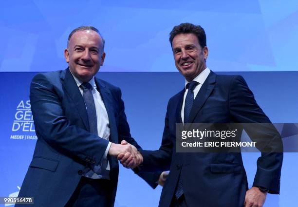 New President of French employers' association Medef Geoffroy Roux de Bezieux poses with former Medef head Pierre Gattaz at the end of a Medef...