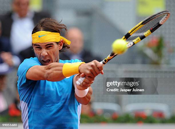 Rafael Nadal of Spain plays a backhand to Oleksandr Dolgopolov of Ukraine in their second round match during the Mutua Madrilena Madrid Open tennis...