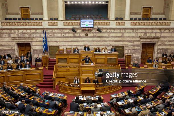 Greek Prime Minister Alexis Tsipras delivers a speech at the parliament ahead of a parliamentary vote on controversial reforms in Athens, Greece, 15...