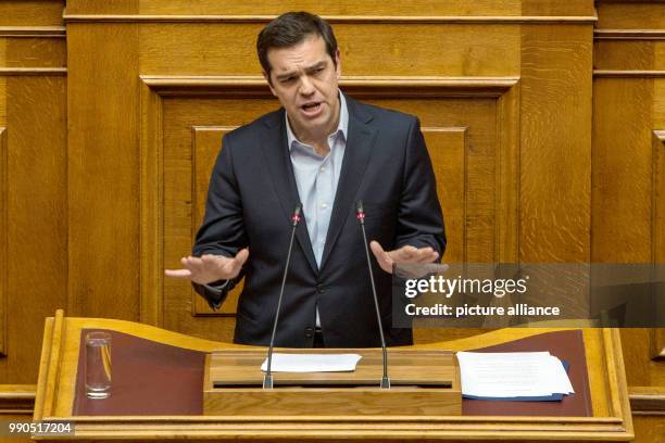 Greek Prime Minister Alexis Tsipras delivers a speech at the parliament ahead of a parliamentary vote on controversial reforms in Athens, Greece, 15...