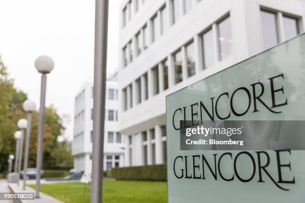 The Glencore company sign sits in the foreground against the backdrop of the Glencore Plc headquarters in Baar, Switzerland, on Wednesday, Sept. 30,...