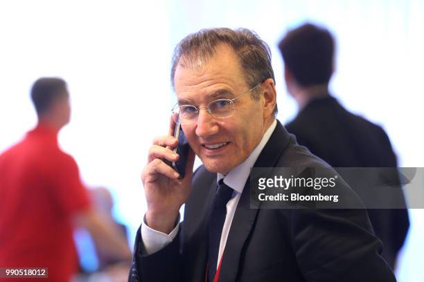 Ivan Glasenberg, billionaire and chief executive officer of Glencore Plc, uses a smartphone while attending the St Petersburg International Economic...