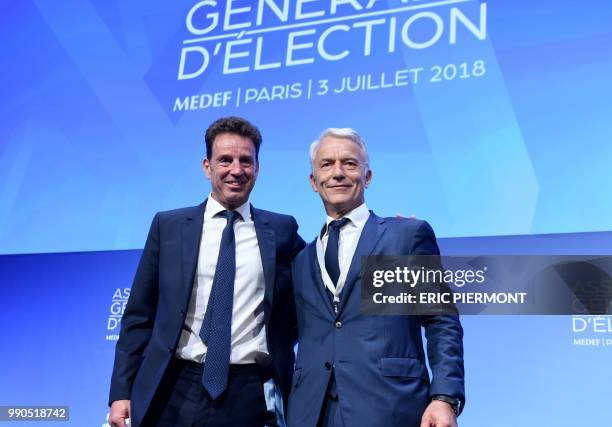 New President of French employers' association Medef Geoffroy Roux de Bezieux and former candidate Patrick Martin pose at the end of the Medef...