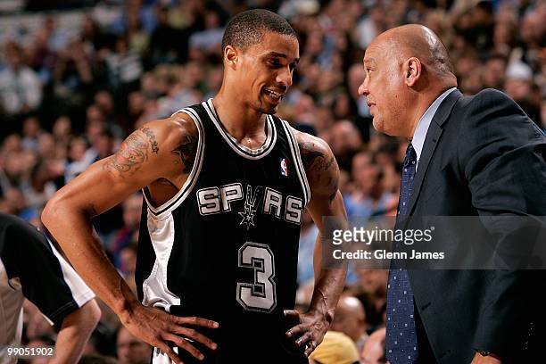George Hill talks to assistant coach Don Newman of the San Antonio Spurs in the game against the Dallas Mavericks in Game Five of the Western...